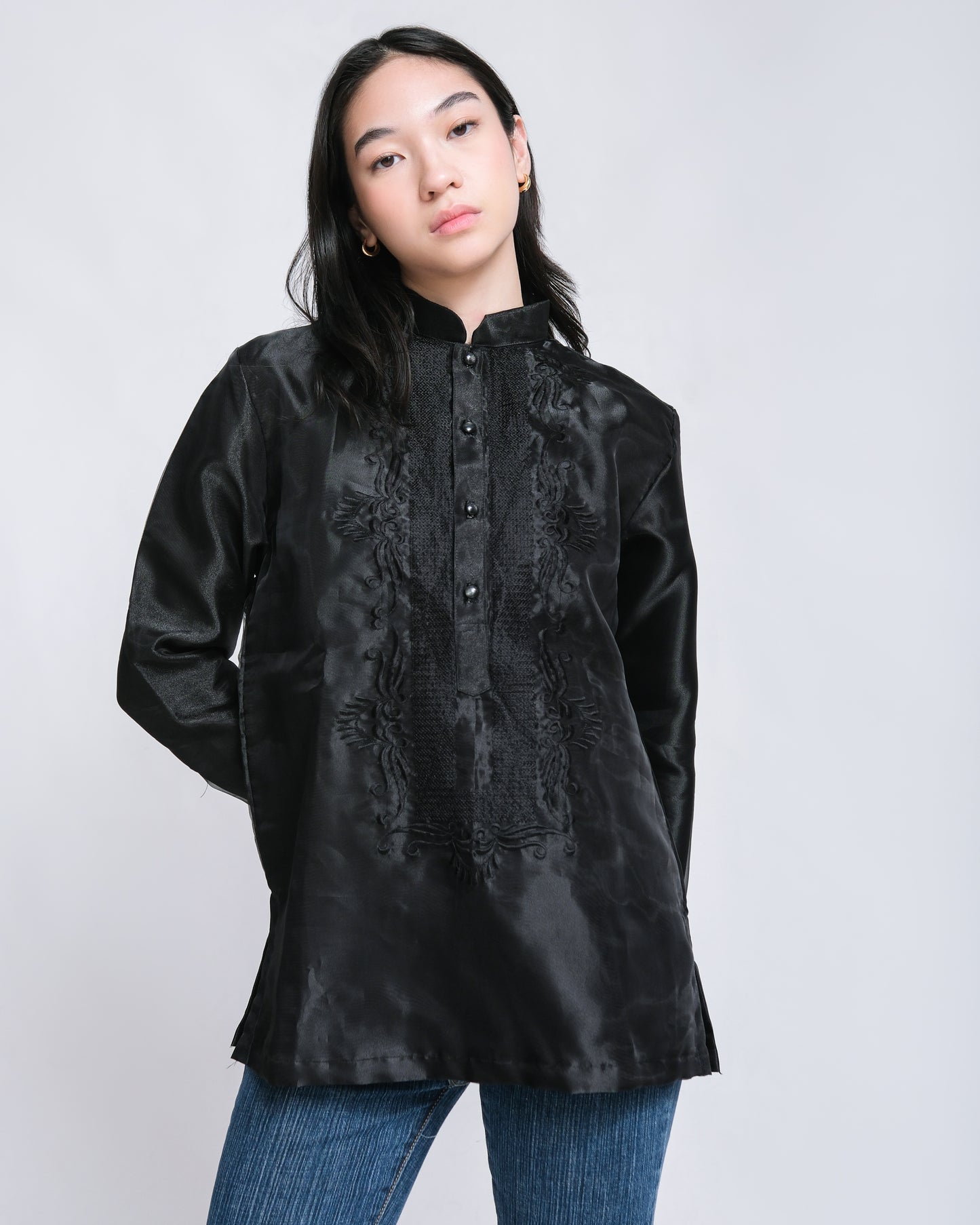 Confident woman wears Enrique modern barong with black floral embroidery, effortlessly paired with jeans