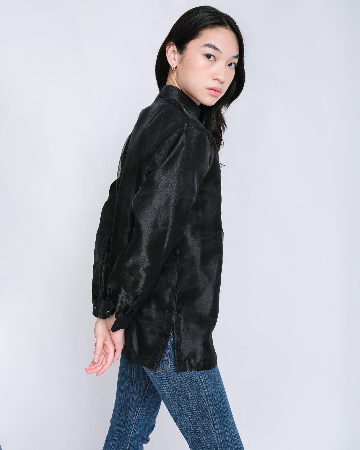 Confident woman wears Enrique modern barong with black floral embroidery, effortlessly paired with jeans