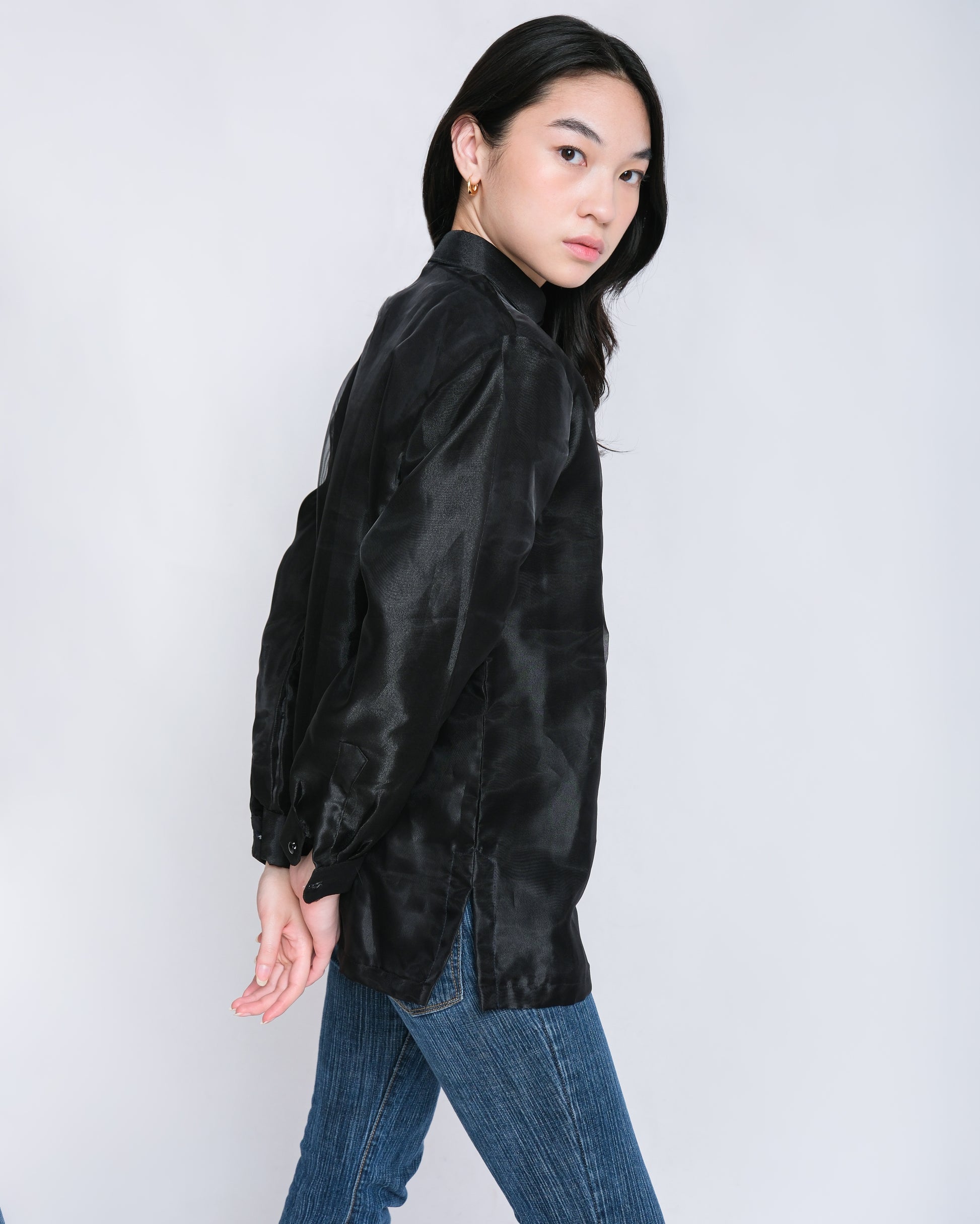 Confident woman wears Enrique modern barong with black floral embroidery, effortlessly paired with jeans