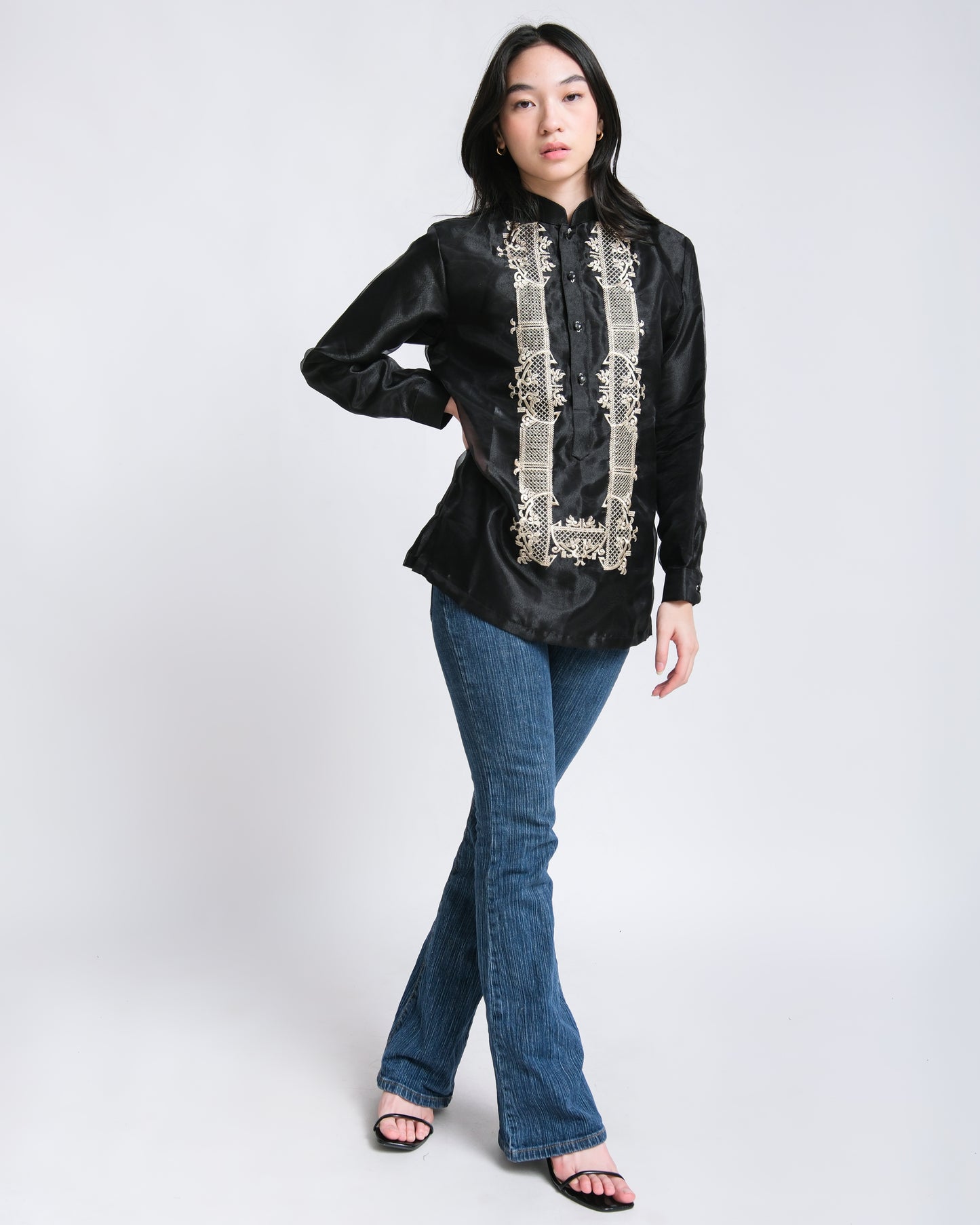 Woman wears Jose modern barong with earthy hues, effortlessly paired with jeans.