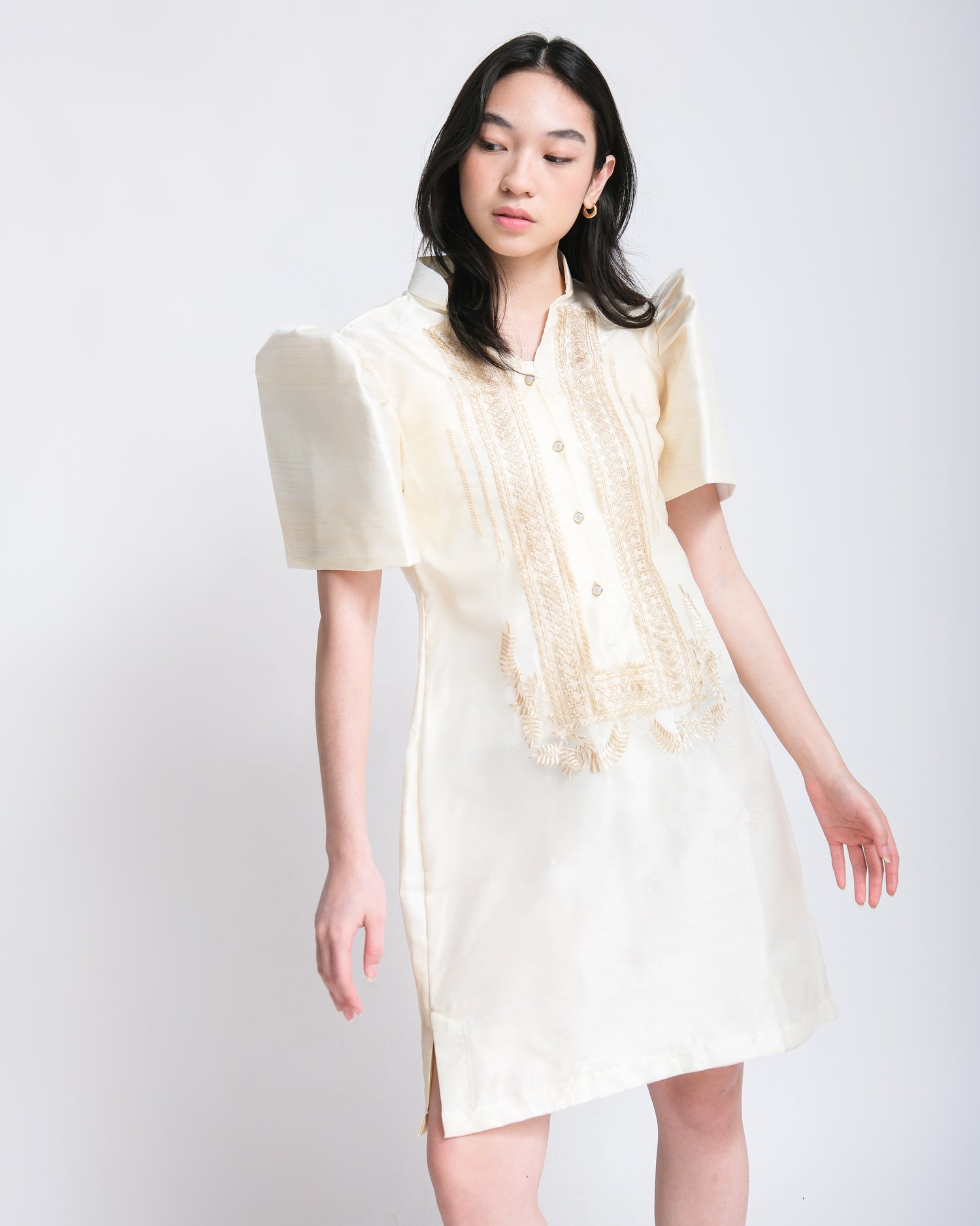 Woman effortlessly wears Olivia Filipiniana dress with cream embroidery and Maria Clara sleeves, exuding timeless elegance